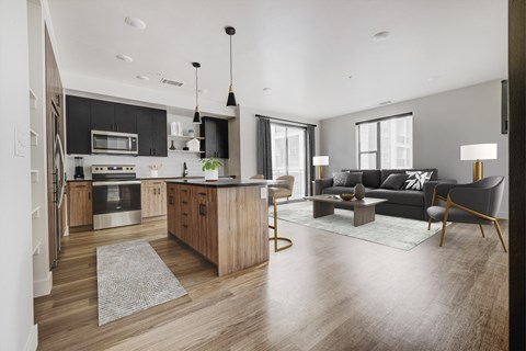 a living room with a kitchen and a couch and a table